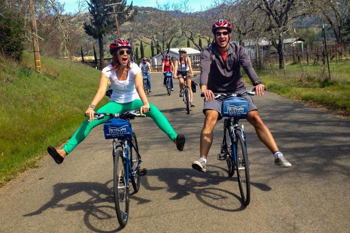 a group of people riding on the back of a bicycle